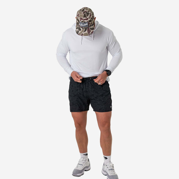Person wearing a white hoodie, black shorts, and a camouflage face mask on a white background