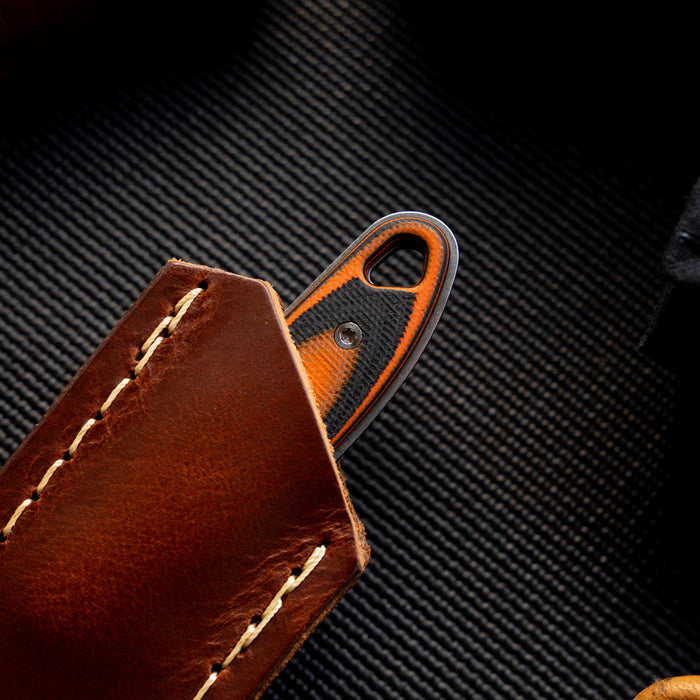 Badrock leather sheath with a concealed pocket carry design, showcasing a knife handle partially visible inside.