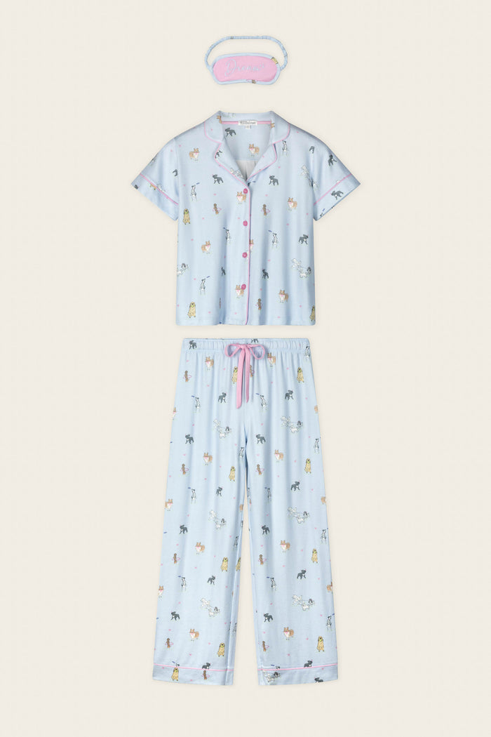 The Bark Park Fetch & Frolic 3-Piece PJ Set by P.J. Salvage features a light blue short-sleeve top, long pants, "Dream" sleep mask, cute animal prints, and pink accents—perfect women's sleepwear for dog lovers.