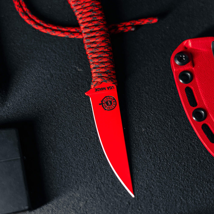 Black and red Blood Brothers Mini-Speedgoat 2.0 knife with a sleek blade and textured handle, ideal for outdoor use.