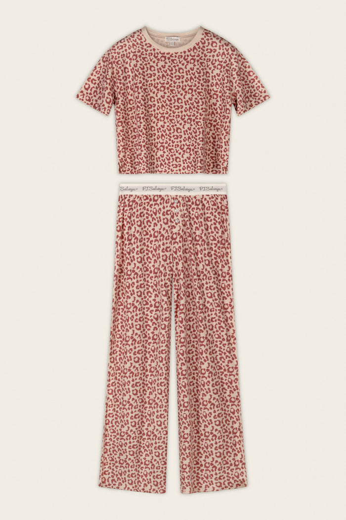 The P.J. Salvage Boyfriend Boxer Leopard Print Short Sleeve & Pants PJ Set features a bold red and white leopard print, with a short-sleeve cropped top and high-waisted, wide-leg pants finished with an elastic waistband.
