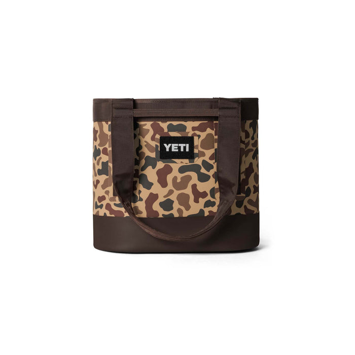 Front view of YETI Camino 35 tote in Wetlands Camo with black logo patch and dual padded carry handles.