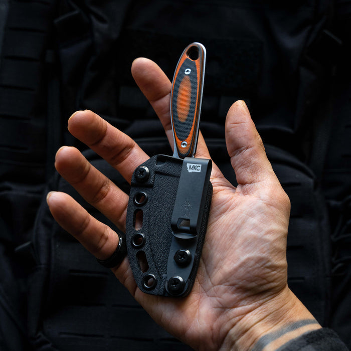 Additional Kydex sheath for the Castle Rock knife, held in a hand, showcasing its secure fit and durable design.