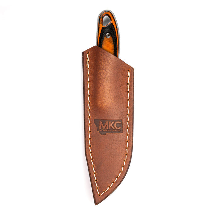 Brown leather sheath for concealed pocket carry, featuring MKC logo and stitched detailing for durability.