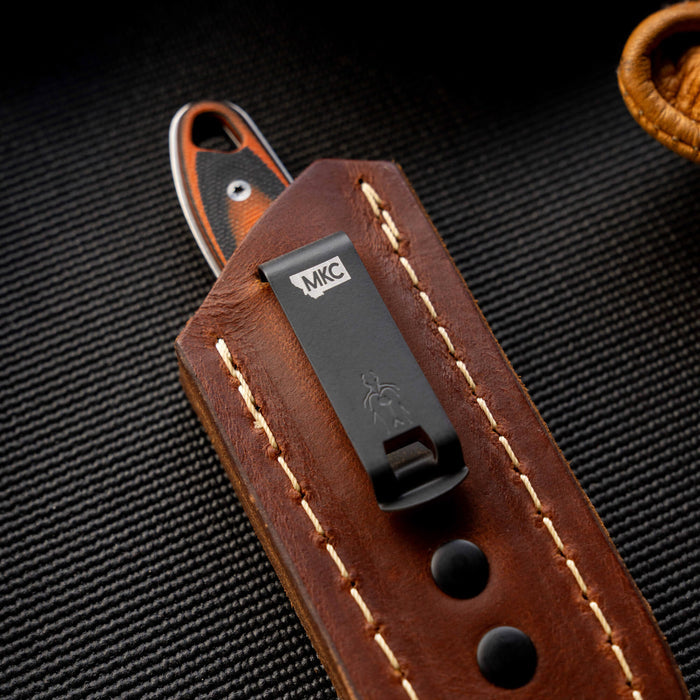 Close-up of the Castle Rock leather sheath featuring a concealed pocket carry design and MKC logo.