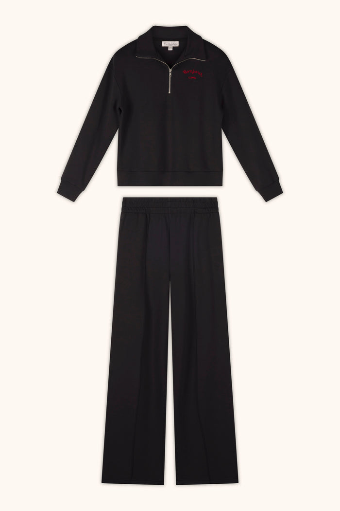 A pair of P.J. Salvage C'est La Vie Midnight Flights Runway Pants, styled with a zip-up long sleeve top, is laid flat on a light background.