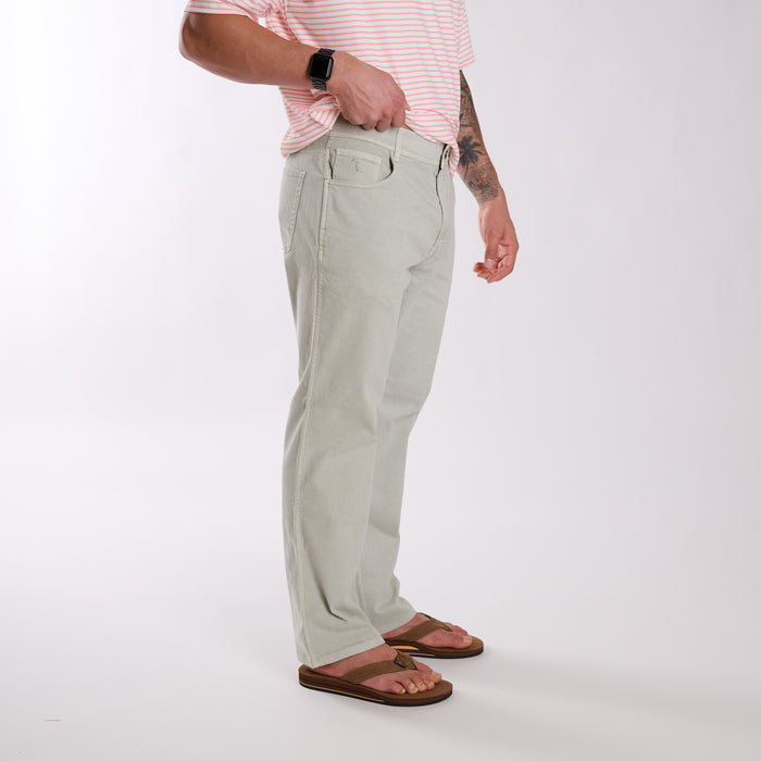 Person wearing light gray pants and a pink striped shirt on a white background
