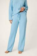 A person wearing the P.J. Salvage Cozy Chenille Cable Knit Cloud Blue Lounge Pants, styled with long sleeves and a drawstring waist, stands barefoot against a plain background.