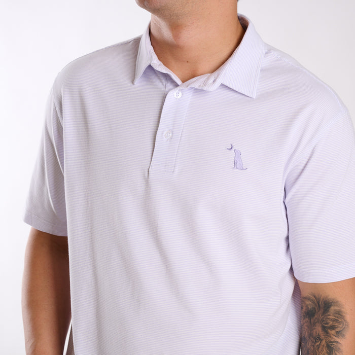 Close up of dog and moon chest emblem on purple and white striped polo.