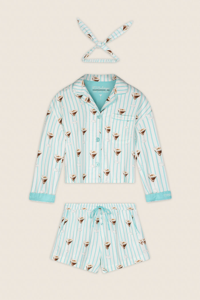 The Espresso Martini Print 3-Piece Flannel PJ Set by P.J. Salvage, featuring a long-sleeve shirt, drawstring shorts, and a matching headband with light blue and white stripes and coffee cup motifs, is laid flat on a cream background.