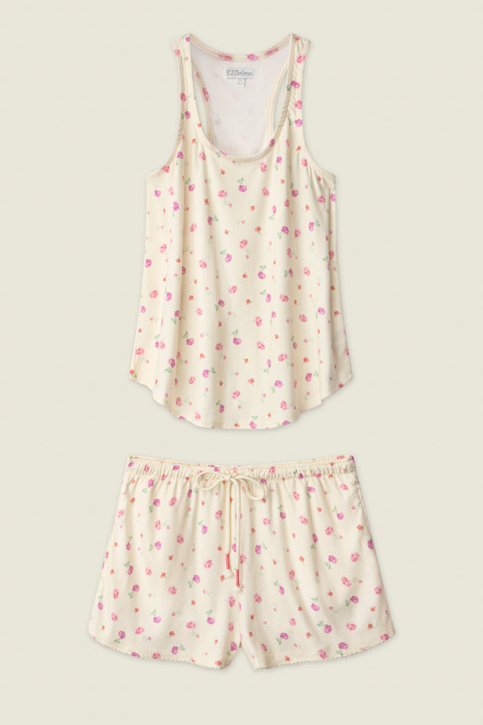 The P.J. Salvage For the Mamas Butter Blooms Short PJ Set features a cream sleeveless tank and drawstring shorts, both adorned with a delicate pink and purple floral print for a charming bedtime look.