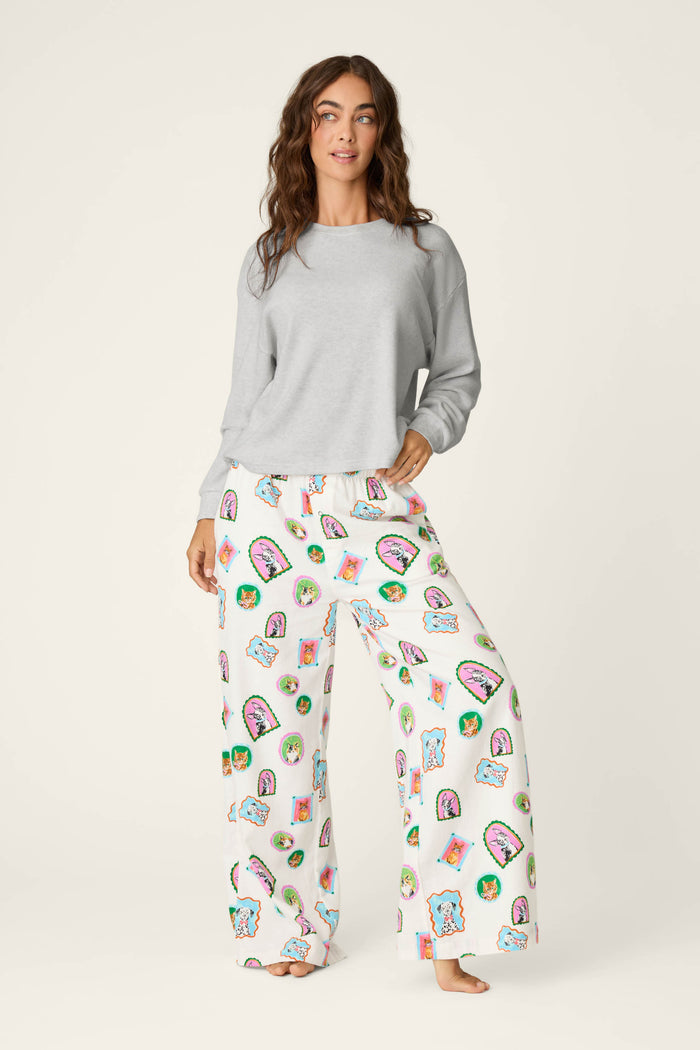 A woman wearing the P.J. Salvage Heather Grey Long Sleeve Top and white pajama pants with colorful taco and cactus prints stands barefoot against a plain light background.
