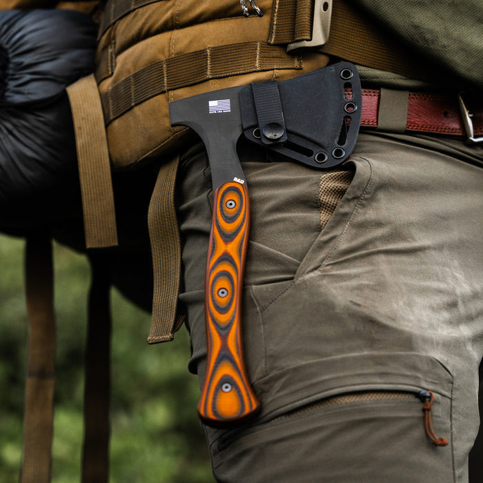 Additional Kydex sheath for the Hellgate Hatchet, securely attached to a tactical belt with a vibrant handle design.