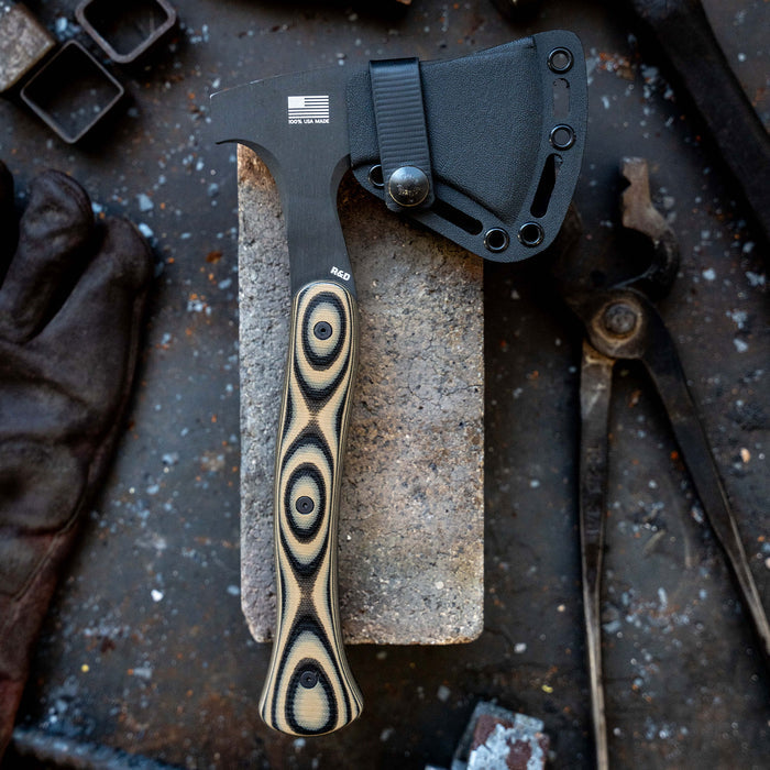 HELLGATE HATCHET with Kydex sheath on a workbench, featuring a textured handle and American flag emblem.