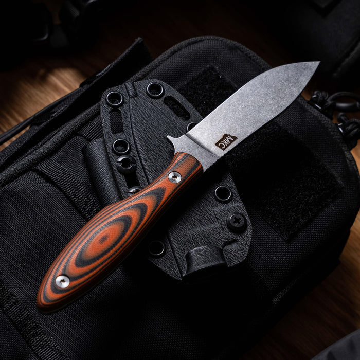 JACKSTONE knife with orange and black handle, featuring a durable blade, resting on a tactical bag.
