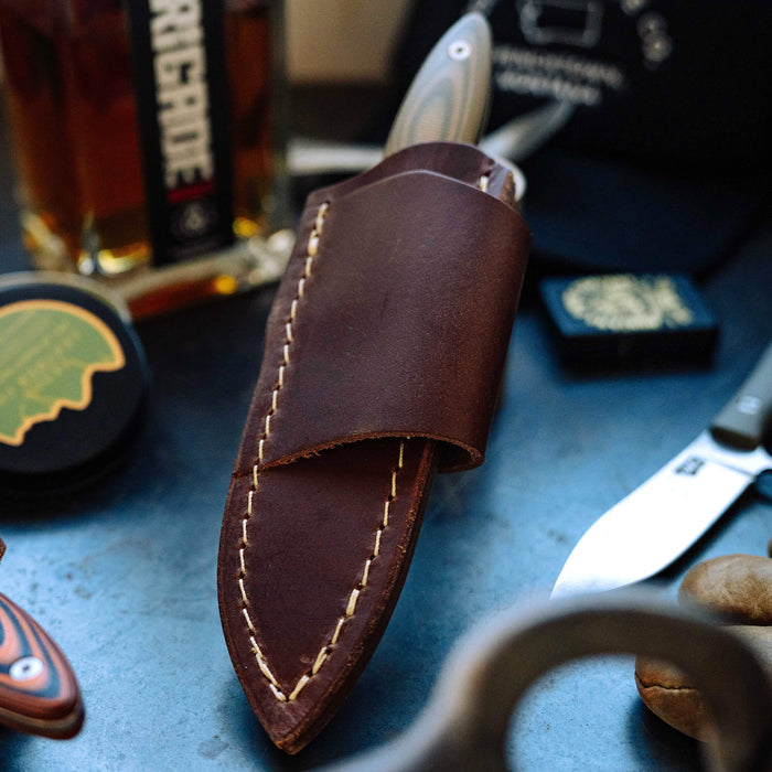 Horizontal leather sheath for JACKSTONE knife, featuring sturdy stitching and a sleek design, ideal for belt carry.