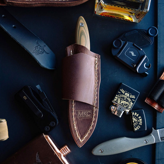 Horizontal leather sheath for JACKSTONE knife, featuring durable stitching and MKC branding, ideal for belt carry.
