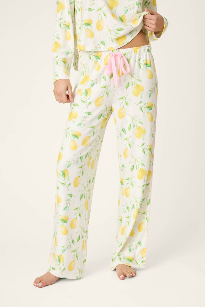 White fabric with a yellow lemon print and pink drawstring accents; matching fabric partially visible in the upper portion.
