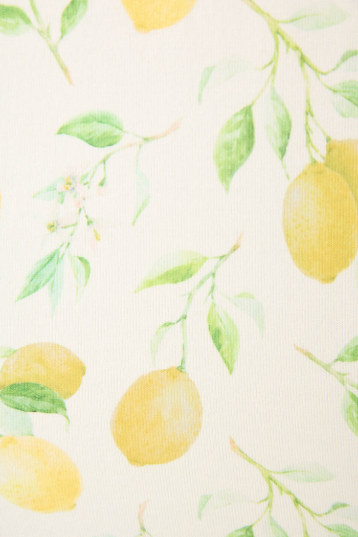 Watercolor-style print of lemons, green leaves, and small blossoms on a light off-white background for a fresh, botanical look.