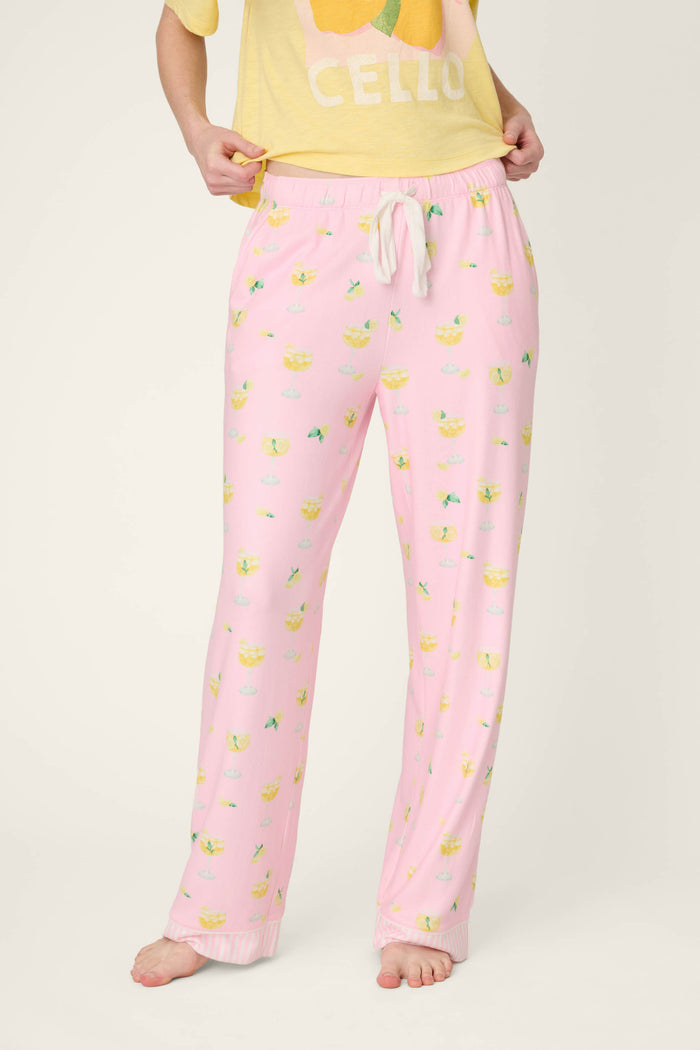 Light pink fabric with a yellow fruit print and drawstring details, paired with yellow textile featuring a large fruit design.