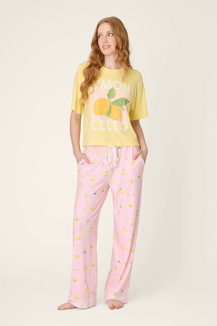 Pattern of small lemons on light fabric with a smooth texture; vibrant yellow t-shirt fabric features a bold lemon graphic.