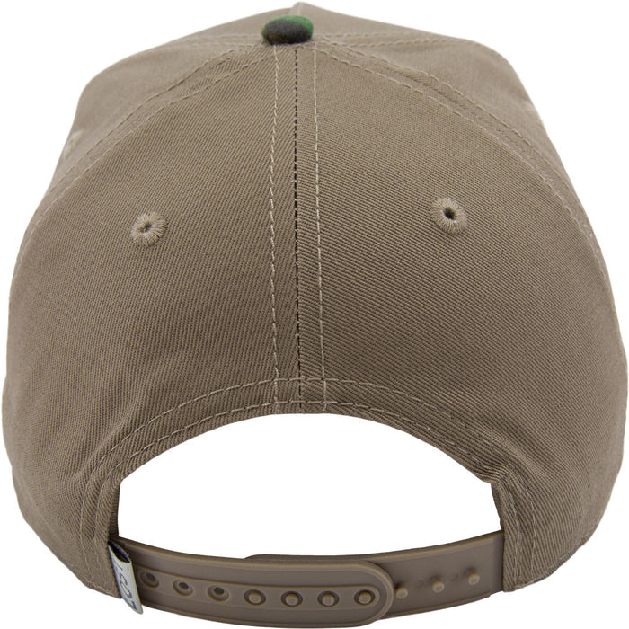 Back view of a brown cap with a green button on a white background