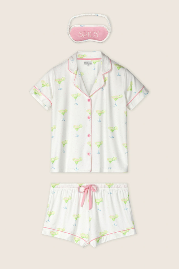 The P.J. Salvage Margarita Mama Spicy Sips 3-Piece Short PJ Set features a margarita-print short-sleeve button-up top, matching shorts with pink trim, and a pink "SPICY" embroidered sleep mask—perfect for fun, relaxing nights.