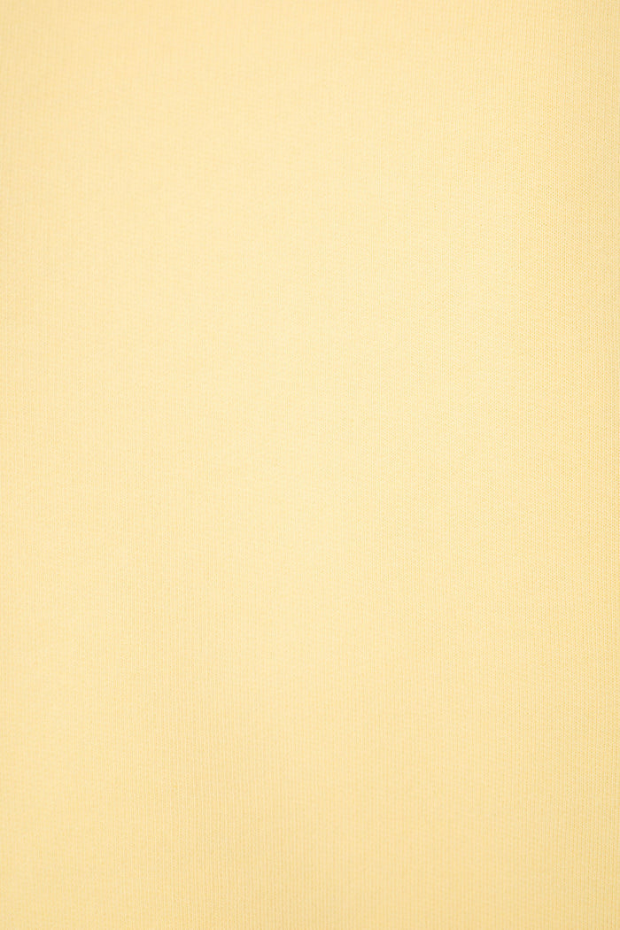 Light yellow textured fabric with subtle vertical lines.