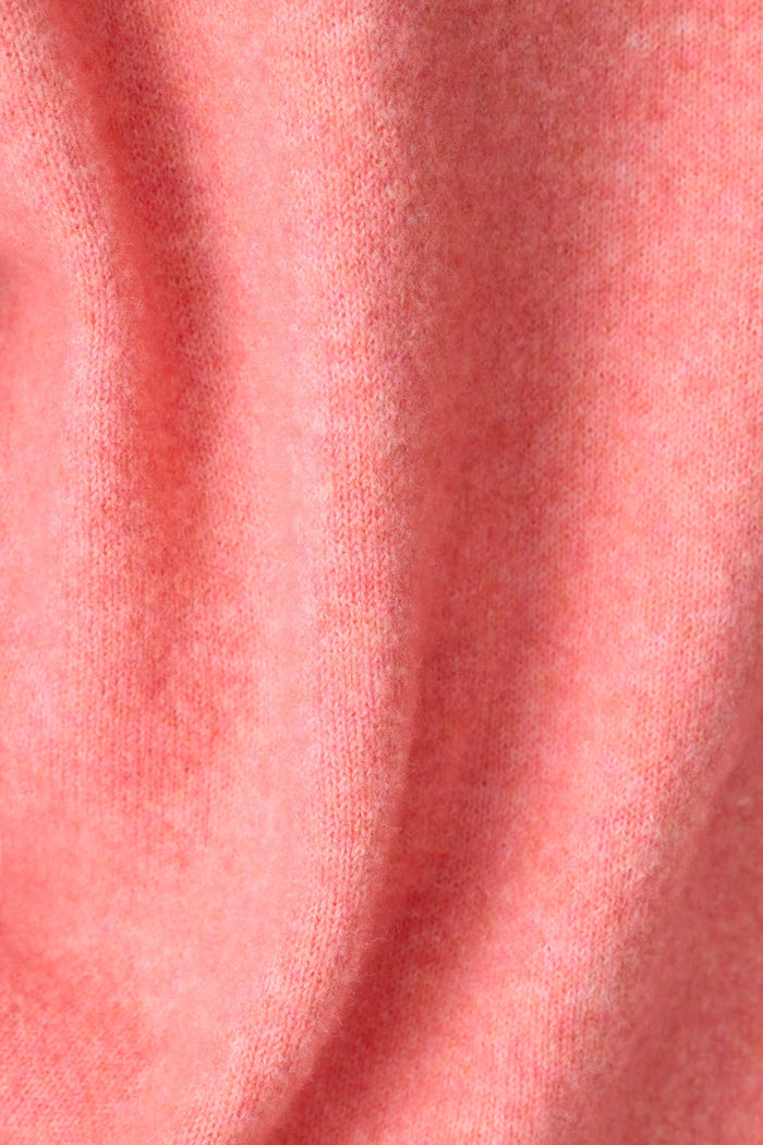 Close-up of the P.J. Salvage Mimosa Please Snuggle Sweater, featuring a soft, textured pink knit with gentle folds and a slightly fuzzy surface.