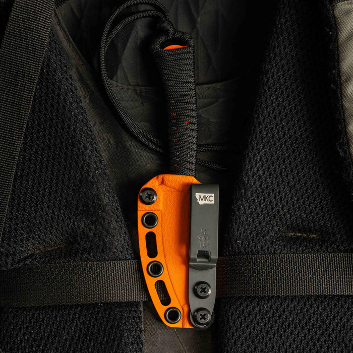 MINI SPEEDGOAT 2.0 knife secured in an orange Kydex sheath, showcasing its durable design for outdoor use.