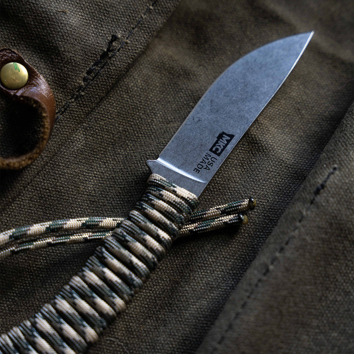 Mini Stoned Goat knife in desert camo with a textured handle and a stainless steel blade, ideal for outdoor use.