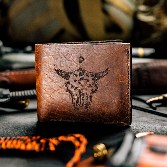 Brown leather wallet featuring a bison skull design, ideal for outdoor enthusiasts and everyday carry.