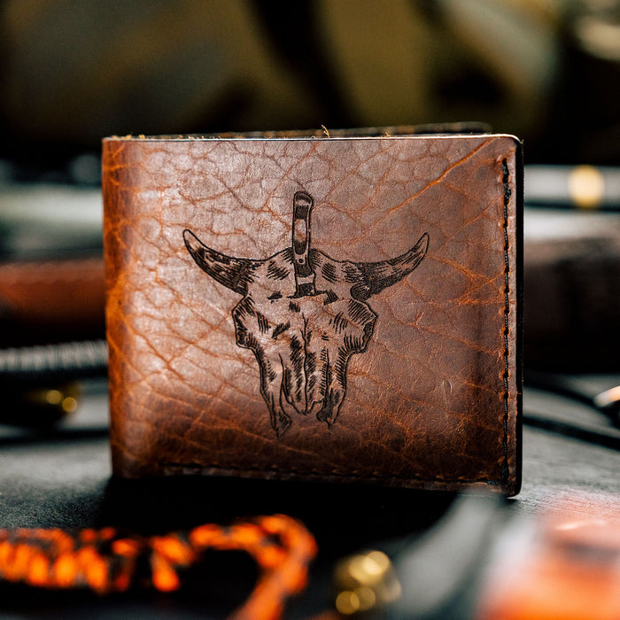Brown leather wallet featuring a bison skull design, showcasing rugged craftsmanship for outdoor enthusiasts.
