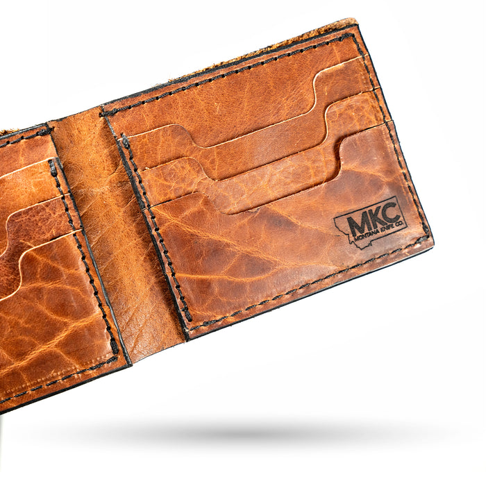 MKC Bison Skull leather wallet showcasing a rich brown texture with card slots and the MKC logo embossed.