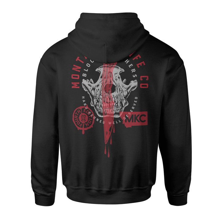 Black hoodie featuring a graphic of a skull with a knife, showcasing the Montana Knife Company Blood Brothers design.
