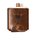Limited run MKC copper flask with a leather sleeve featuring a bull skull design, ideal for outdoor enthusiasts.