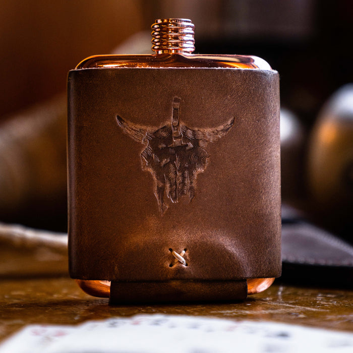 Limited run MKC copper flask with leather wrap featuring a bull skull design, ideal for outdoor enthusiasts and collectors.