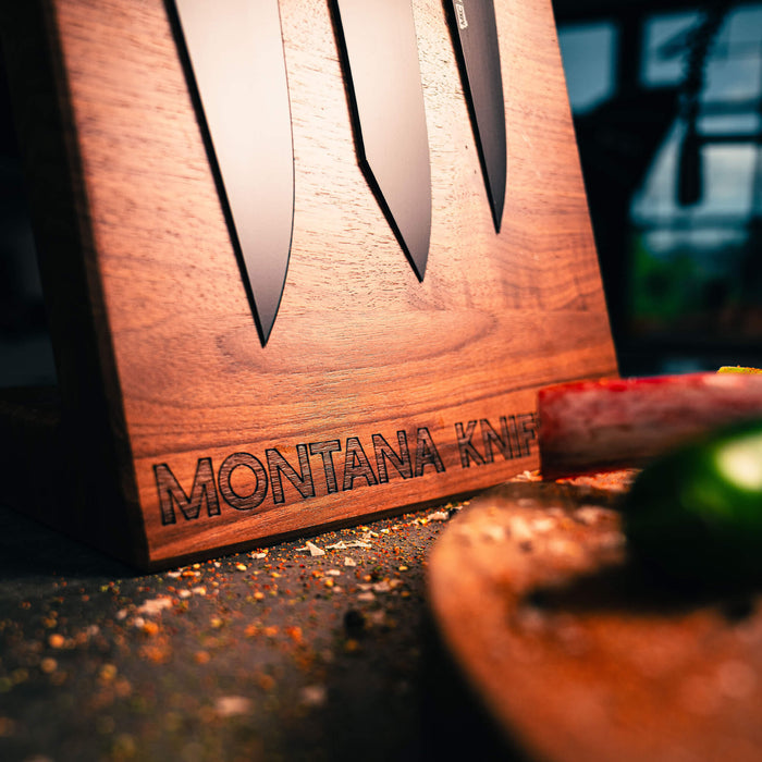MKC Culinary double-sided knife stand in dark wood finish displaying knives, with spices and a cutting board in the foreground.