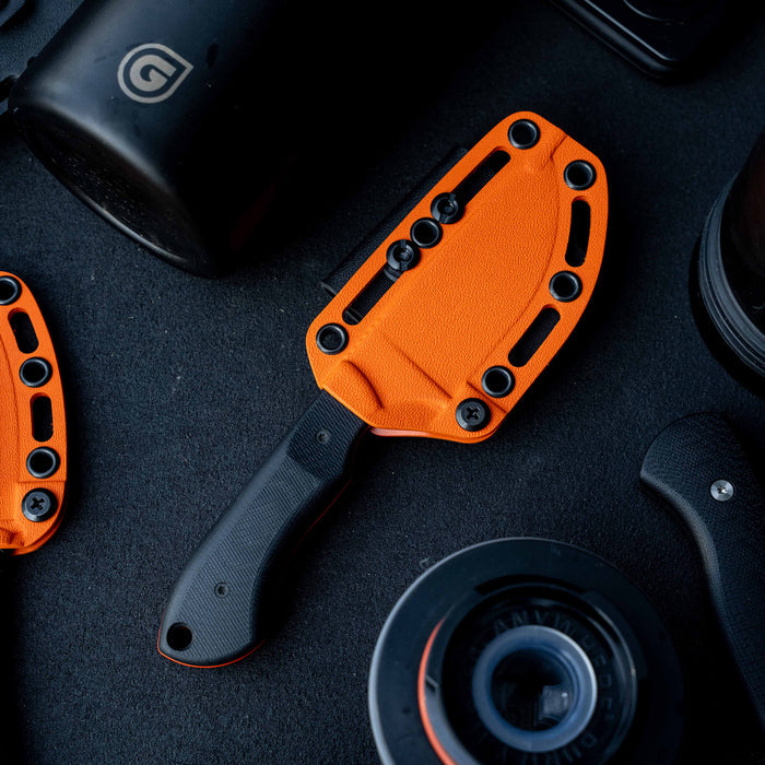 MKC Elk Knife with an orange Kydex sheath, designed for durability and outdoor use, showcasing its rugged features.
