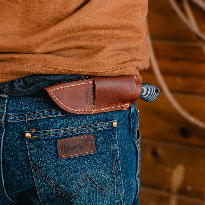 Horizontal leather sheath for MKC Elk Knife, securely attached to a belt, showcasing durability and craftsmanship.