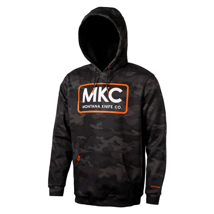 Dark woodland camo fleece hoodie featuring the MKC logo, designed for outdoor enthusiasts and working professionals.