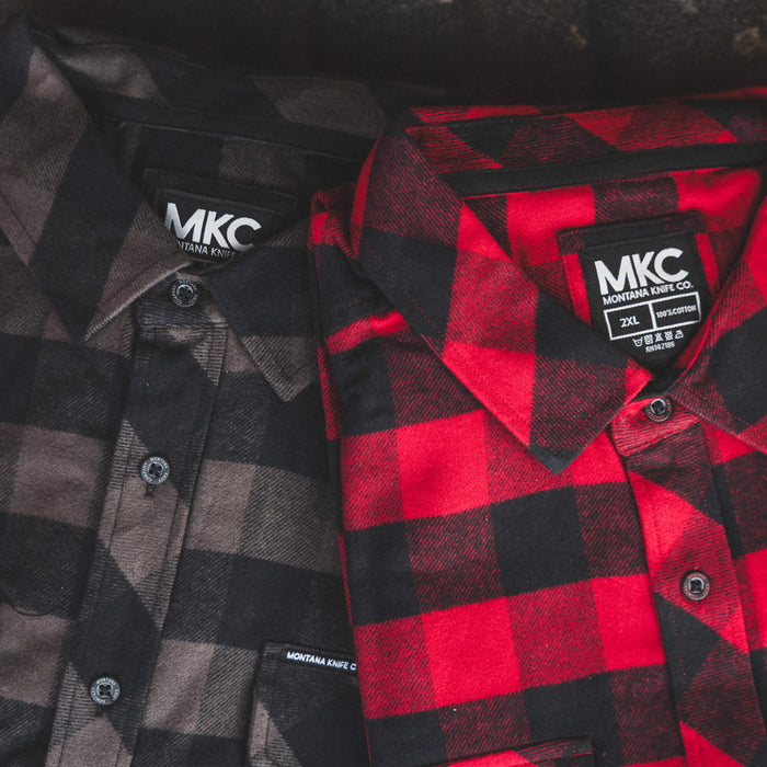 Red and black plaid MKC Heavyweight Flannel shirts, showcasing durable fabric and classic design for outdoor wear.