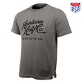 Stone-colored t-shirt featuring Montana Knife Co logo and "Made in the USA" text, showcasing American craftsmanship.