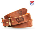 Brown leather belt from Montana Knife Company featuring a sturdy buckle and embossed logo, made in the USA.