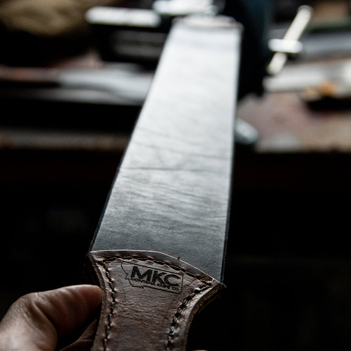 MKC Leather Strop made in the USA, featuring a smooth surface for sharpening knives, held in a hand.