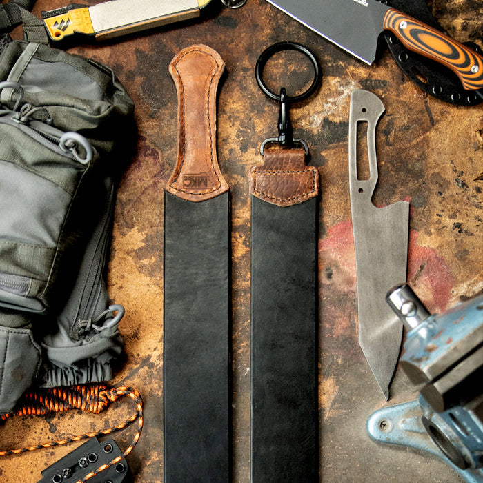 MKC Leather Strop made in the USA, featuring two strops with leather handles, surrounded by knives and outdoor gear.
