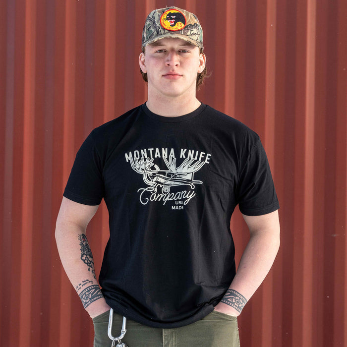 Black Montana Knife Company Moose Tee displayed on a model, featuring a graphic logo and a casual fit.