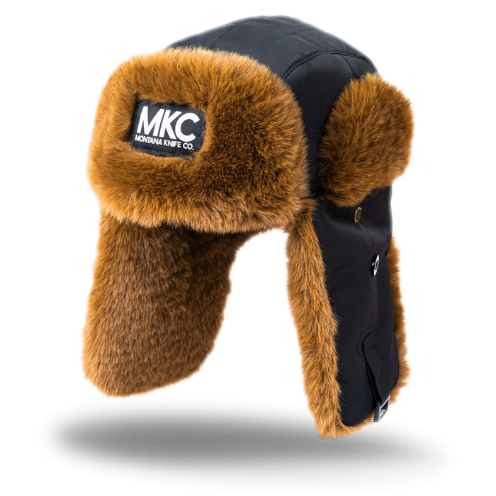 MKC Trapper Hat featuring a black exterior and warm faux fur lining, designed for outdoor enthusiasts and cold weather.