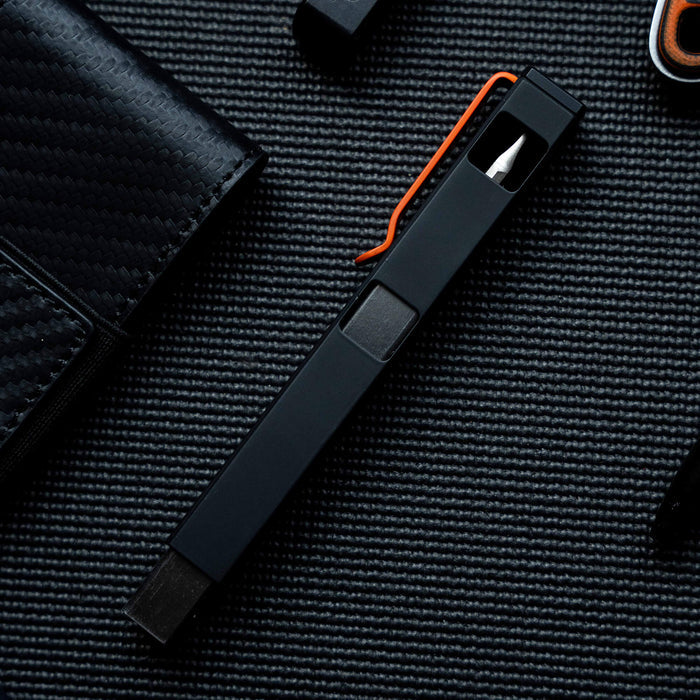 MKC X BIG IDEA DESIGN BIT BAR INLINE MAX, a sleek black multi-tool with an orange clip, designed for everyday carry.