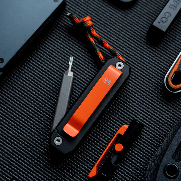 Montana Knife Company Ti EDS II, a compact EDC tool with an orange clip, screwdriver, and durable design for everyday use.